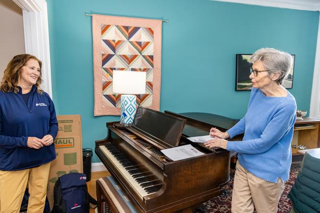 Two Caring Transitions team members with a happy client.