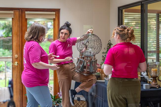 Three Caring Transitions team members prepping an estate sale