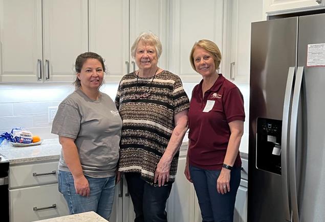 Caring Transitions team members with happy client